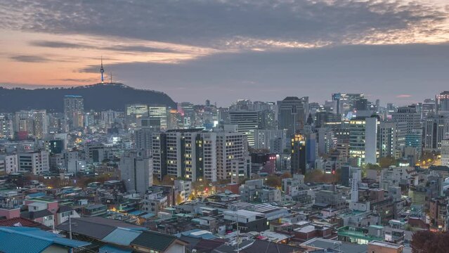 Seoul South Korea time lapse 4K, city skyline day to night sunset timelapse at Seoul city center view from Naksan Park in autumn