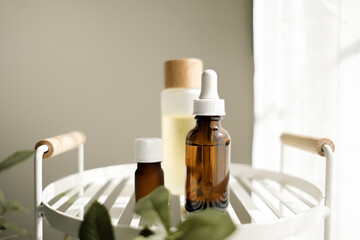 The natural skincare bottle on the white shelf in the bathroom for self-care and beauty concept. Selective focus