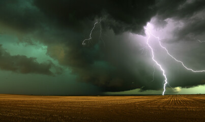 lightning over the field - obrazy, fototapety, plakaty