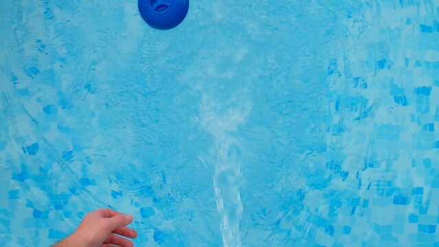 pool Filter. hand throws a cleaning filter in blue water of the pool.slow motion.Pool water filtration. Blue water filter.Swimming pool cleaning. High quality 4k footage