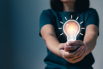 Person hand holding light bulb showing ideas creative concept, thinking inspiration, innovation technology, AI (Artificial Intelligence), educational technology, deep learning, startup.