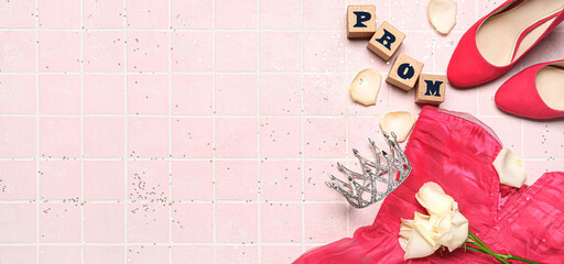 Cubes with word PROM, tiara, female dress, shoes and roses on pink tile background with space for...