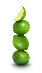 Stacked whole and cut limes on white background