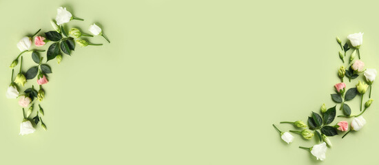 Composition with eustoma and rose flowers on green background with space for text