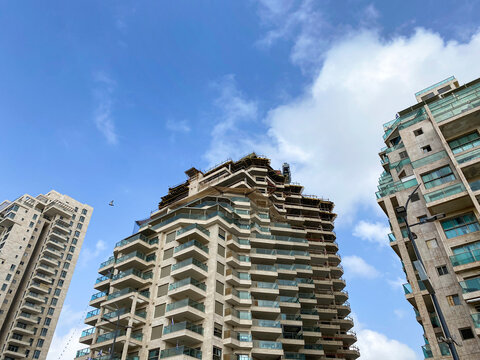 View of multi-storey buildings against blue sky