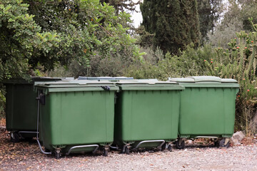 Green garbage containers in park