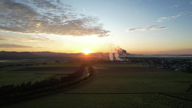Spectacular sunrise and sunset at Proserpine Queensland Australia with sugar mill in full operation in the background