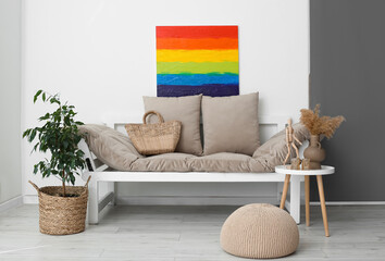 Interior of light living room with rainbow painting and couch