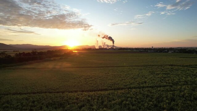 Spectacular sunrise and sunset at Proserpine Queensland Australia with sugar mill in full operation in the background