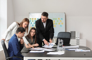 Group of people working on business plan in office