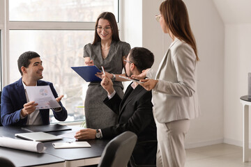 Group of people working on business plan in office