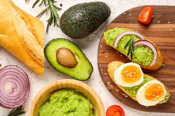 Fototapeta na wymiar Composition with ingredients for delicious avocado toast on white grunge background
