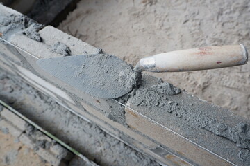 selectively focus on the dirty cement spoon because it is used to install bricks, in Indonesian the cement spoon is called cetok, soft focus