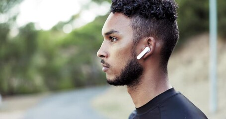 Fitness, runner and music with a sports man listening to audio while outdoor for a cardio or endurance workout. Exercise, running and earphones with a male athlete streaming the radio while training