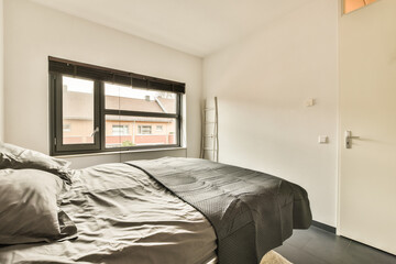 a bedroom with a bed, window, and door to another room in the same building as seen from the outside
