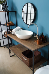 Interior of bathroom with white sink, mirror and shelving unit