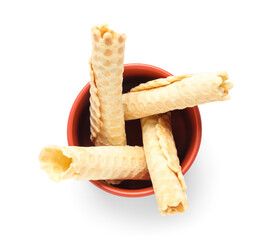 Bowl with delicious wafer rolls isolated on white background