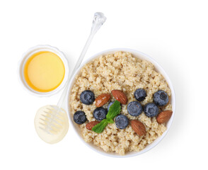Bowl of delicious cooked quinoa with almonds, honey and blueberries on white background, top view