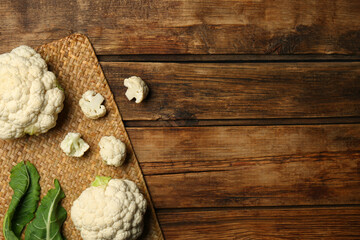Fresh cauliflower on wooden table, top view. Space for text