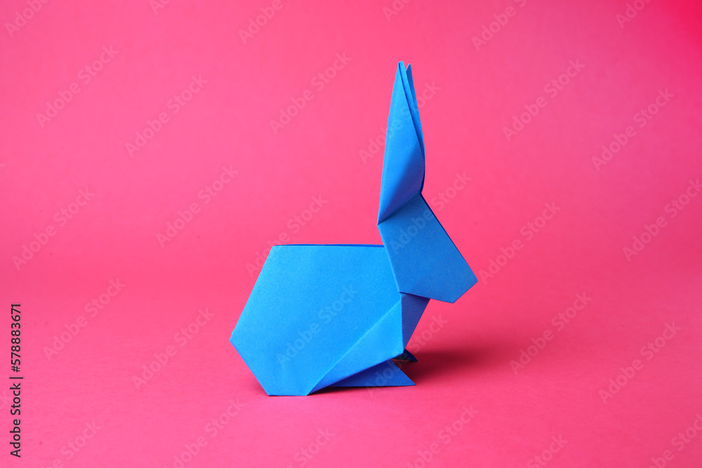 Sticker Light blue paper bunny on pink background. Origami art