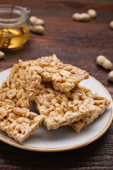 Delicious peanut bars (kozinaki) on wooden table