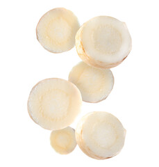 Slices of fresh parsley root falling on white background