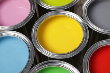 Open cans of different paints as background, closeup