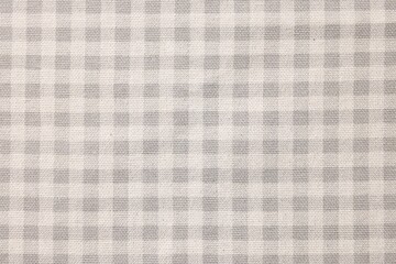 Beige checkered tablecloth as background, top view