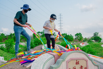Chonburi, Thailand, 9, April, 2018: Chinese descendants cleaning tomb and offering prayers to ancestors during in Qingming Festival ,Tomb-Sweeping Day