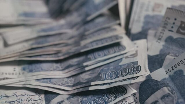 close up dolly shot of 1000 Pakistani currency notes