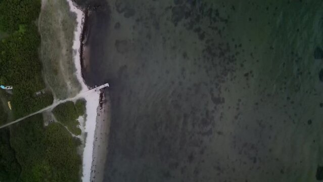 Aerial Topdown of Beach and Ocean at Sunset