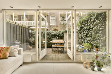 a living room with sliding glass doors that open up to the patio and backyard area in front of the...