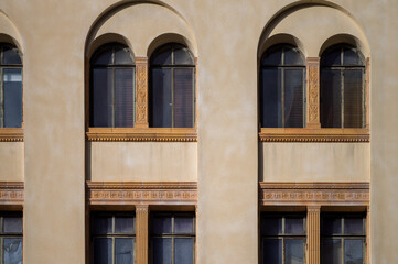 Yellow Facade and Arched Windows on a Beige Wall.