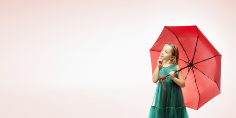 cute little girl with umbrella on color background with copy space. cute thoughtful child girl. panoramic banner.