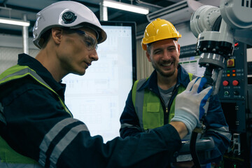 Multiracial tachnicial engineer training with robot arm