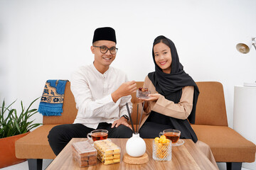 Asian Muslim couples are doing a greeting pose as a symbol of forgiveness. Asian Muslims are...