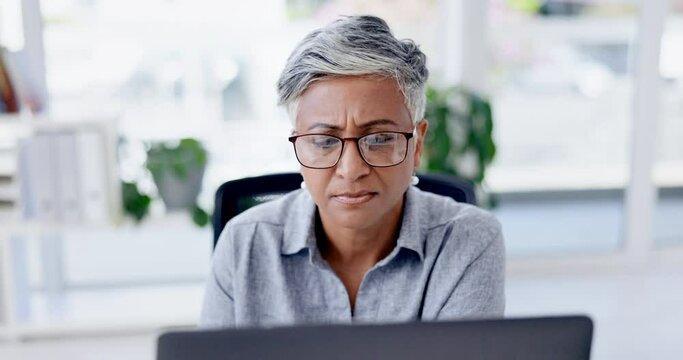 Business woman or boss on laptop with reading glasses for email, software management or data analysis in office. Thinking, serious or planning senior manager or female on computer for online research