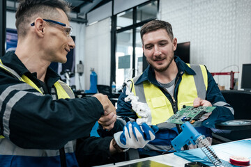 Multiracial tachnicial engineer training with robot arm