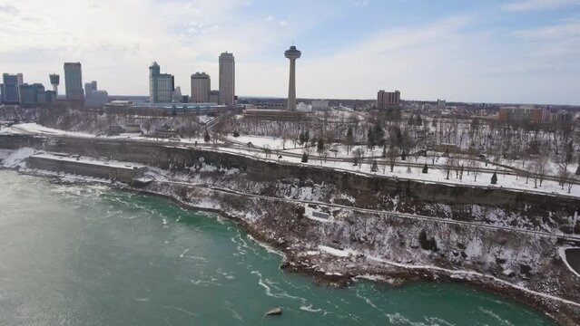 Slow aerial pan of Niagara Falls skyline and Skylon Tower in winter