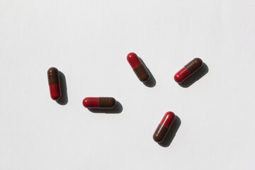 red and brown color pills on a white background.