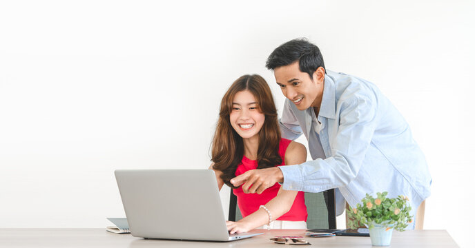 Young Adult Southeast Asian Couple Man And Woman Using Laptop Computer At Home