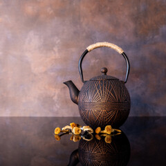 Brown metal tea kettle with dried mushrooms