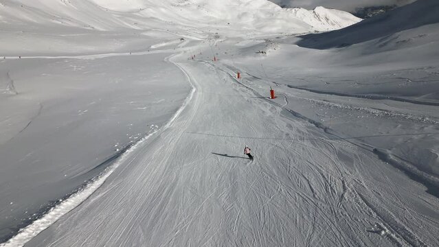 Aerial Follow of Female Skiing down Ski Hill in Serfaus Austria