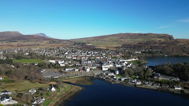 High rise over calm harbour showing Portree Isle of Skye Scotland