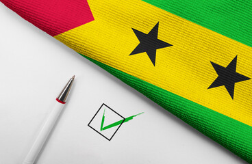 pencil, flag of Sao Tome and Principe and check mark on paper sheet
