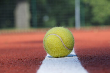Tennis scene with white line and ball and racquets