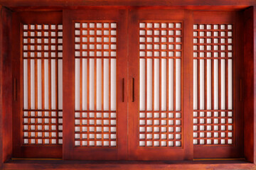 Wooden material window of asian traditional architecture. Dark and red brown Door of Korean traditional with traditional pattern.