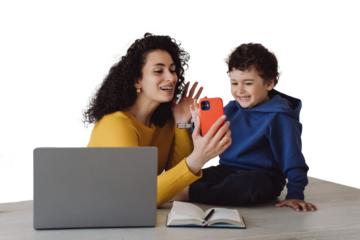 Brunette woman in yellow sweater with braces sitting with little son talking with grandparents by phone, making video call. Curly housewife with adorable curly son against transparent background.