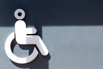 Light box icon handicapped’s toilet on gray wall in gas station