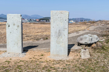 Two vertical slabs of cut stone, ruins of exterior wall of stone fortress in Yeosu, South Korea.